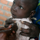 A child being immunized against measles at a clinic in a camp for displaced people in eastern Congo.